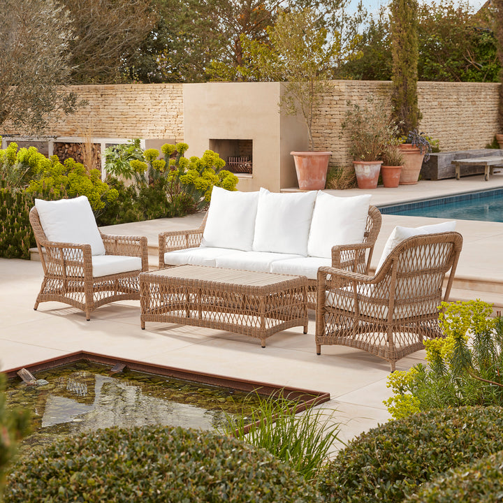 Timeless five seater large lounge set for garden gatherings and light lunches. Set on a patio surrounded by structured greenery, overlooking a contemporary pond.