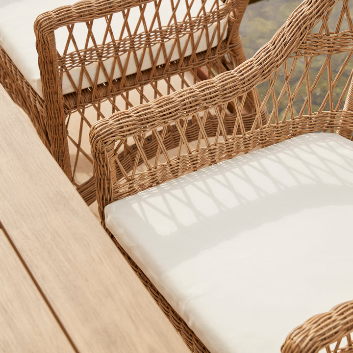 Thick white comfortable garden chair cushions on an all weather rattan dining chair