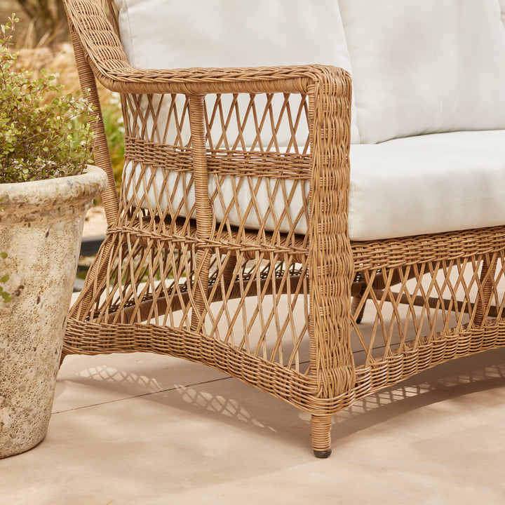 Wicker-style rattan armchairs with white seat cushion