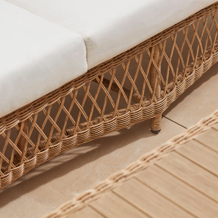 Thick white comfortable garden sofa cushions on an all weather rattan sofa, deep generous seating for all day lounging