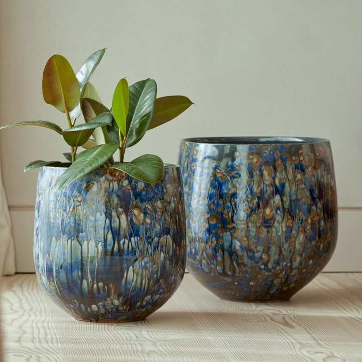 Azura Indoor Plant Pots in two sizes, featuring a rich blue glaze with organic textural detailing, displayed in a contemporary setting.