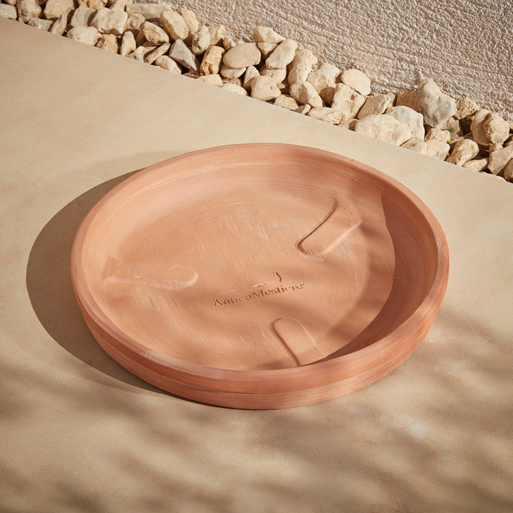 An Italian terracotta plant pot saucer handmade in Italy and perfect for UK gardens.