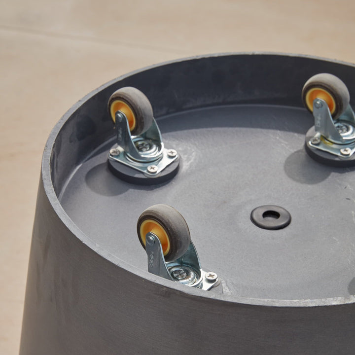 Close-up view of the tall metal planter’s caster wheels, designed for easy movement and repositioning in garden and patio spaces.