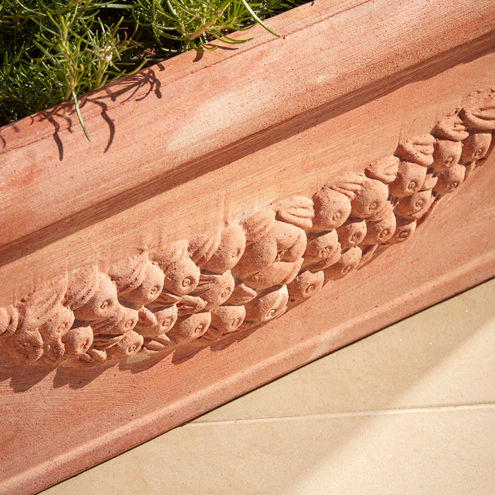 Close up of the Fiorella trough planter with hand pressed festoon garland, authentic to tuscan plant pot designs
