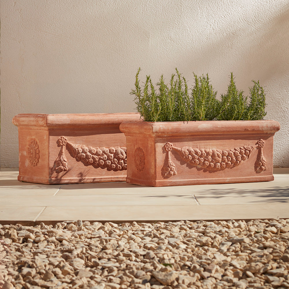 Pair of handcrafted Italian terracotta garden troughs in two sizes, made from authentic Galestro clay and featuring an ornate festoon garland. Perfect for Mediterranean-style outdoor spaces in the UK