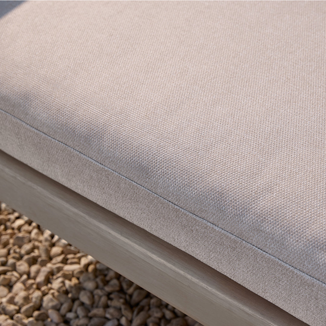 Close-up of a beige cushion on a wooden corner sofa