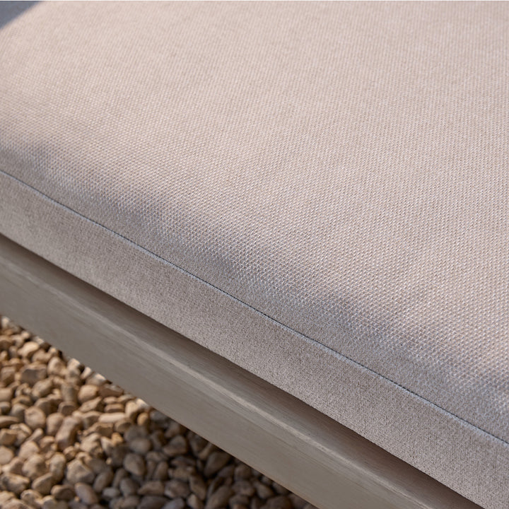 Close-up of a beige cushion on a wooden corner sofa
