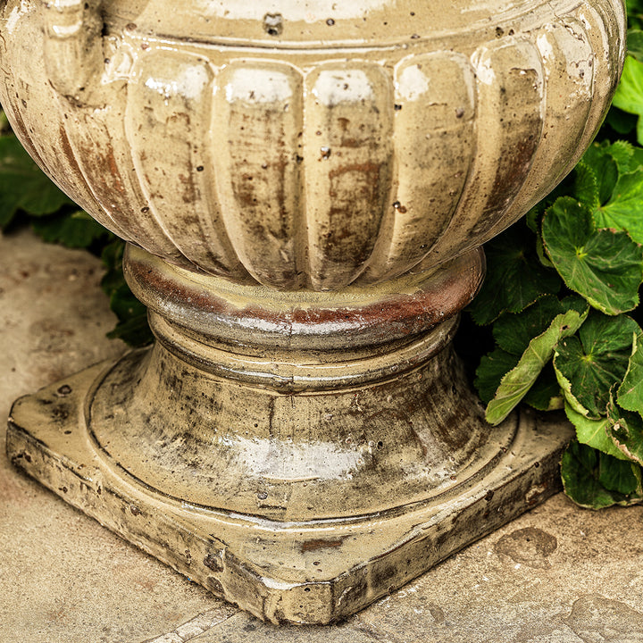 Close-up of large urn planter in honey glaze finish with ribbed base and handcrafted detail.