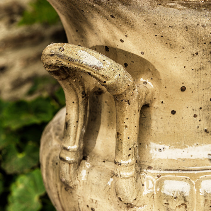 Detailed view of handle on large urn planter in honey glaze, showing textured handcrafted design.