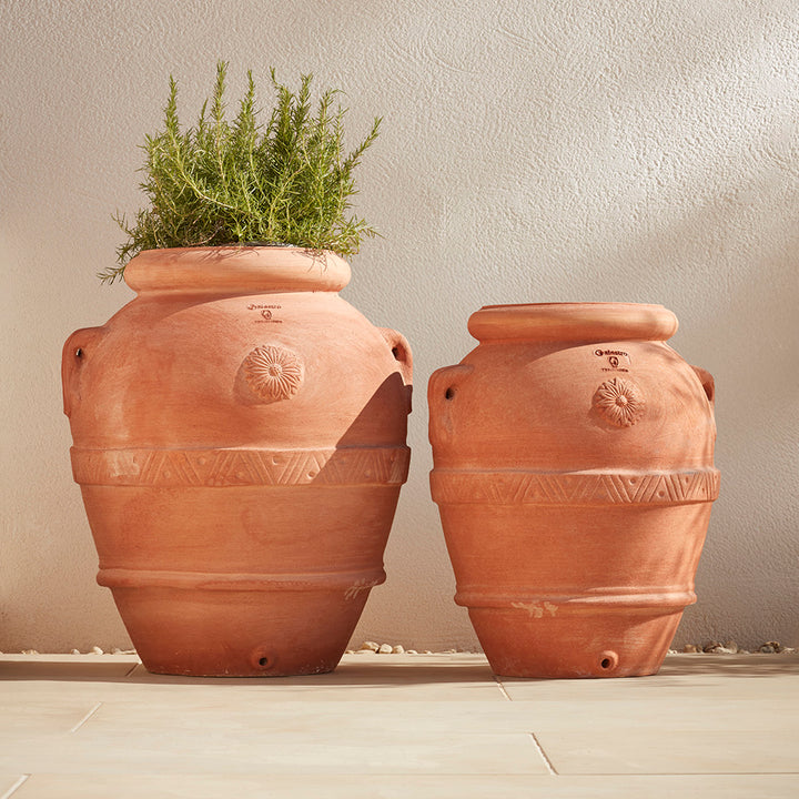 Pair of handcrafted Italian terracotta garden pots in two sizes, made from authentic Galestro clay, perfect for Mediterranean-style outdoor spaces in the UK