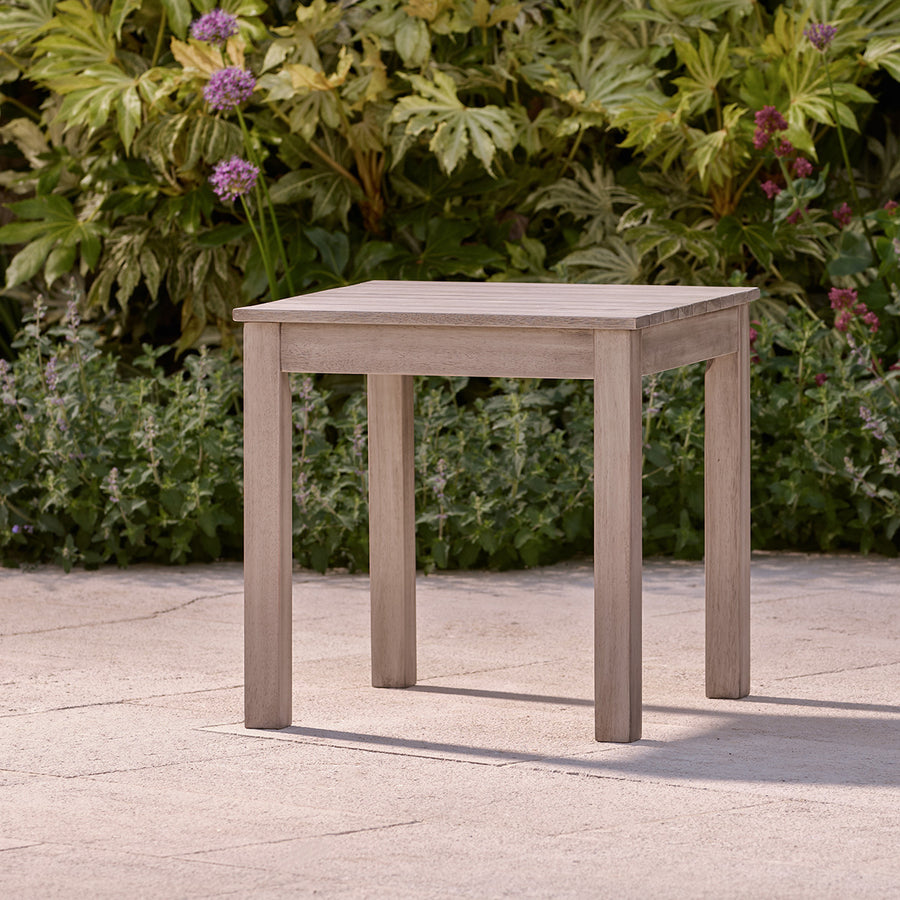 Square grey wooden garden furniture table with slatted top, ideal for patios, courtyards, or small seating areas.