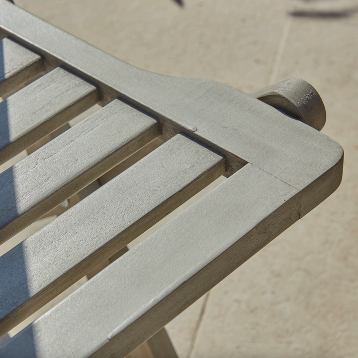 Close-up of the Repton Wooden Dining Chair's slatted backrest, showcasing its smooth weathered grey finish and sturdy craftsmanship. The high-quality wood construction and classic design make it a durable and stylish choice for outdoor garden, patio, and balcony seating.