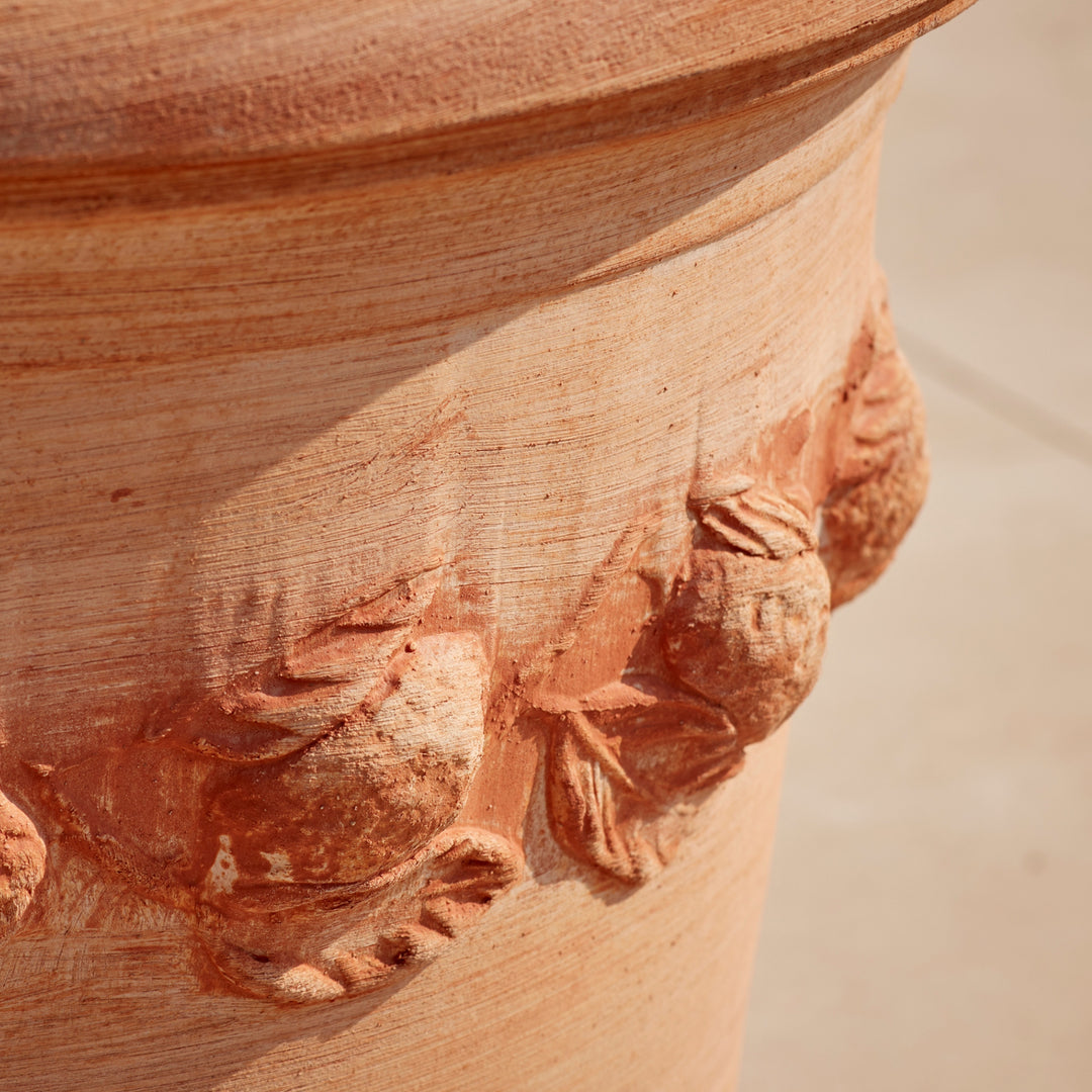 Detailed view of the raised floral motif on the Sorrento Citrus Terracotta Pot, showcasing its artisanal craftsmanship and natural terracotta finish.