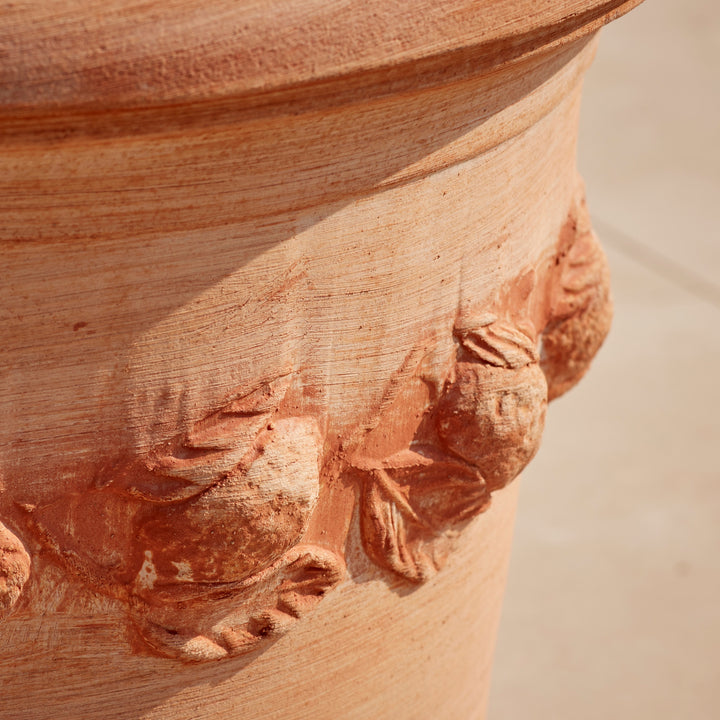Detailed view of the raised floral motif on the Sorrento Citrus Terracotta Pot, showcasing its artisanal craftsmanship and natural terracotta finish.