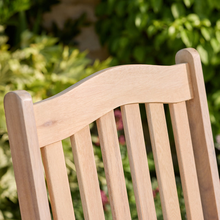 Wooden chair with a blurred green garden background
