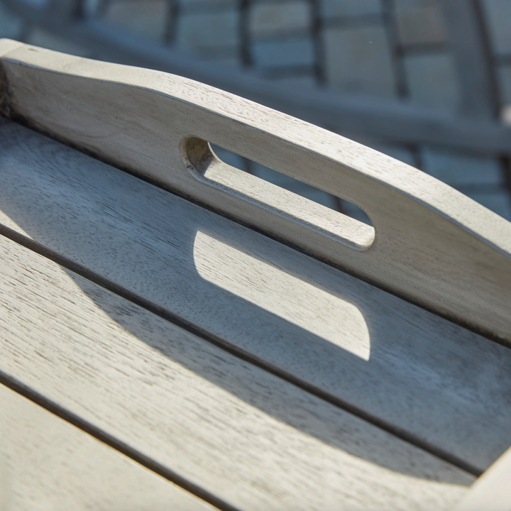 Ergonomic handle cutout on the Repton tray table, designed for easy carrying from kitchen to garden.