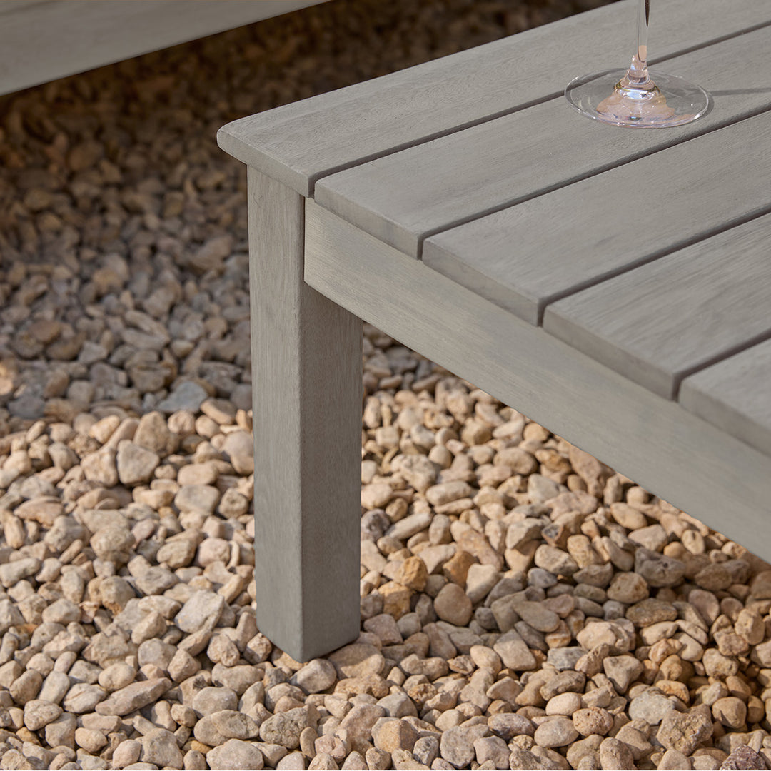 Gray outdoor garden table with a wine glass