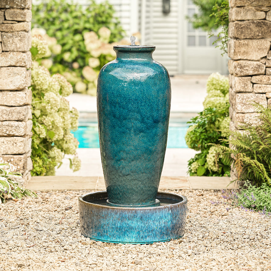 Blue glazed urn water feature with textured bowl base, water gently cascading down.