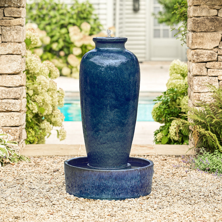 Blue glazed urn water feature with textured bowl base, water gently cascading down.