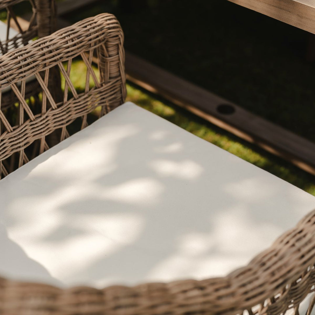 Detail of hand woven open weave design on garden armchair