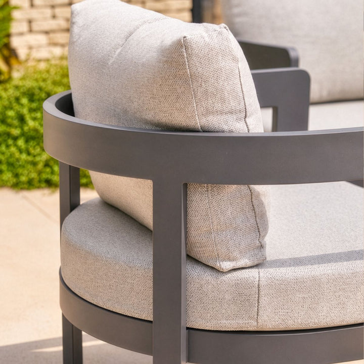 Close-up of curved anthracite aluminium garden chair with textured outdoor cushions