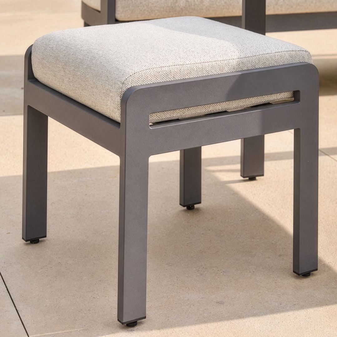 Contemporary garden stool in anthracite grey with minimalist aluminium design and soft seat pad