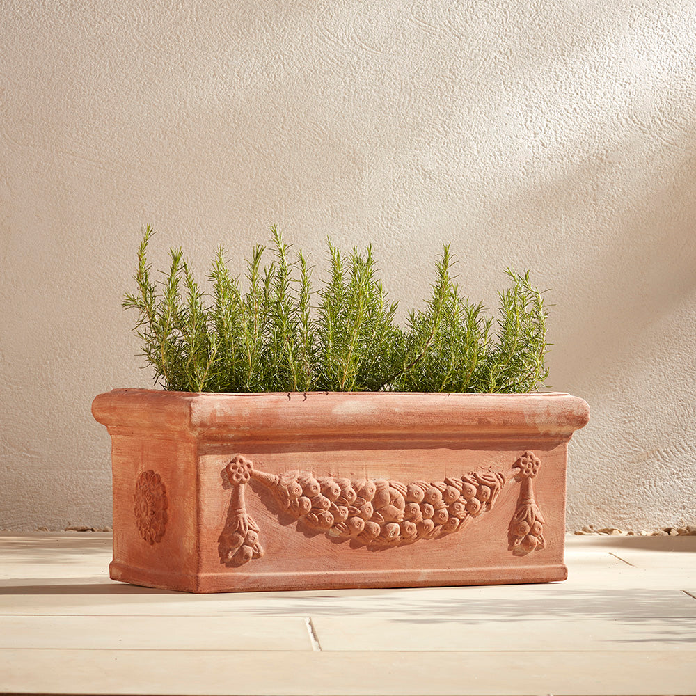 Large Italian Terracotta Trough Windowsill Planter filled with fragrant rosemary, and positioned in a sunny place on a Mediterranean patio