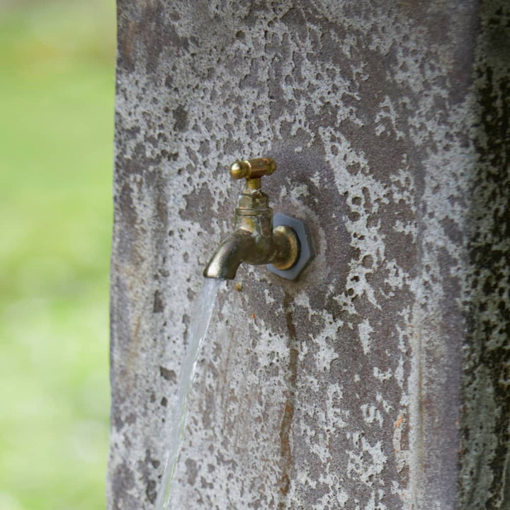 Close-up of the brass tap fixture on the Ancient Stone Garden Fountain, highlighting its vintage-inspired detailing.