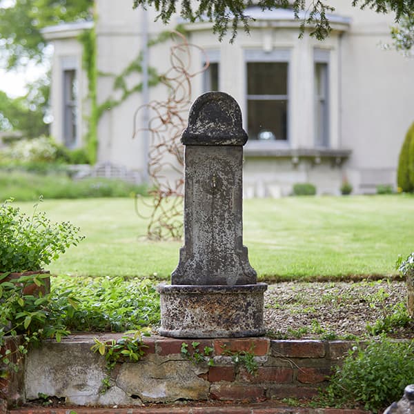 Tall stone garden water fountain in a premium antique glaze 