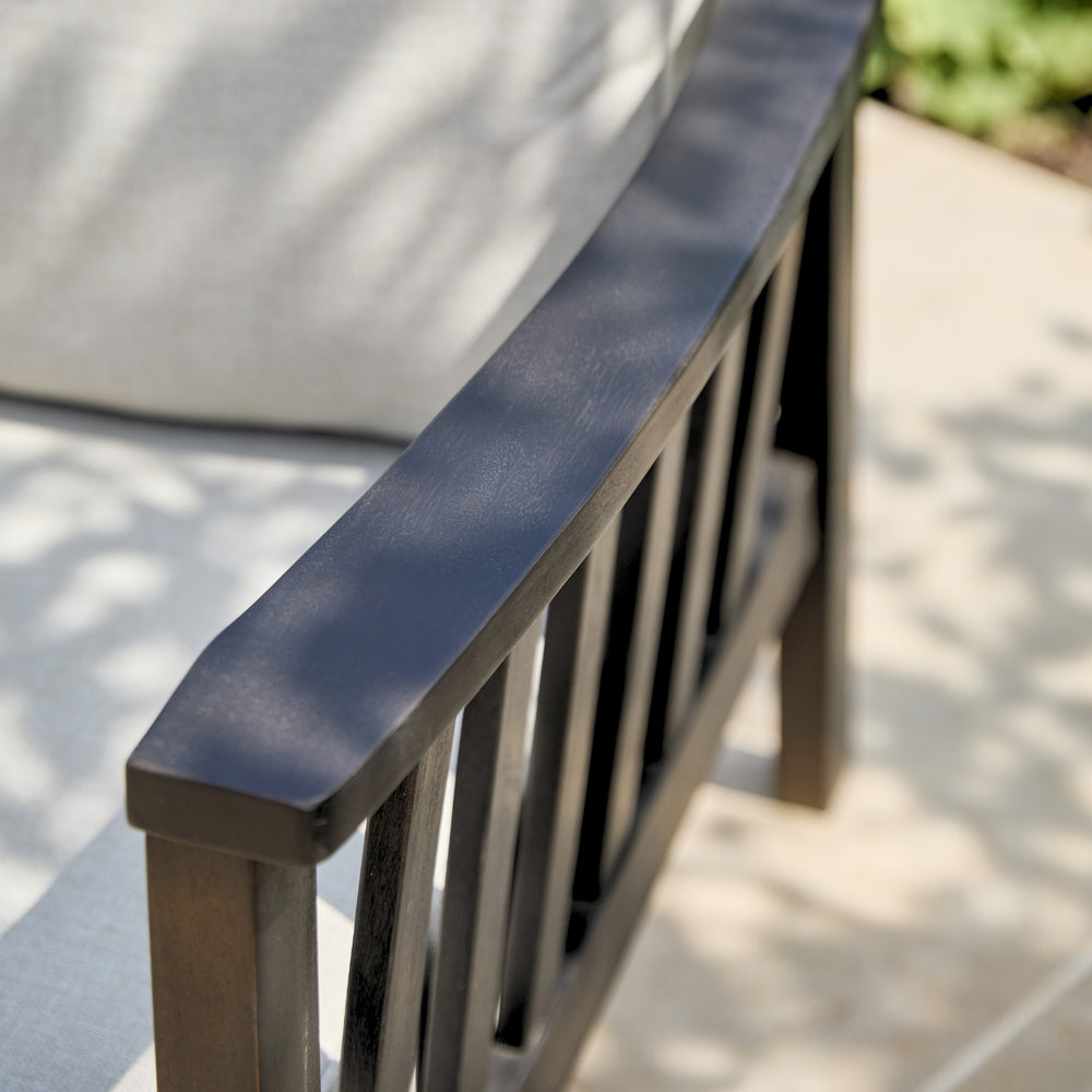 Rounded armrests on a wooden garden armchair showing craftsmanship and beautiful acacia wood grain 