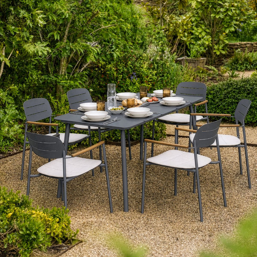Modern six seater outdoor dining set in anthracite powder-coated steel with cream seat cushions