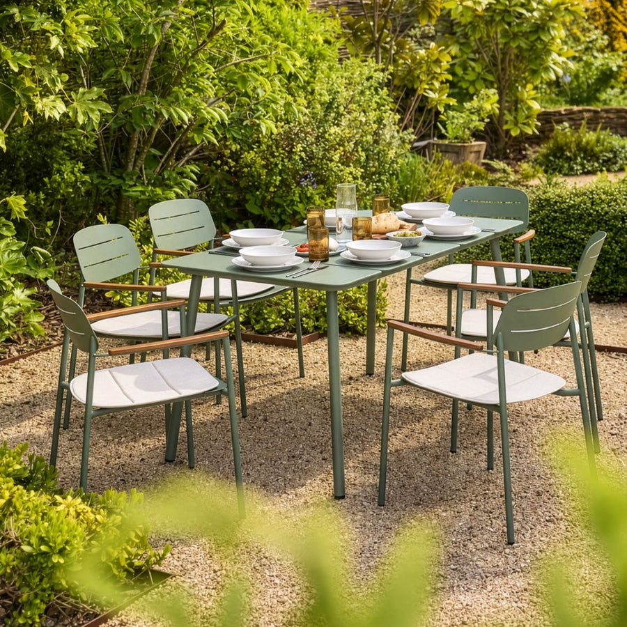 Modern six seater outdoor dining set in sage green powder-coated steel with cream seat cushions