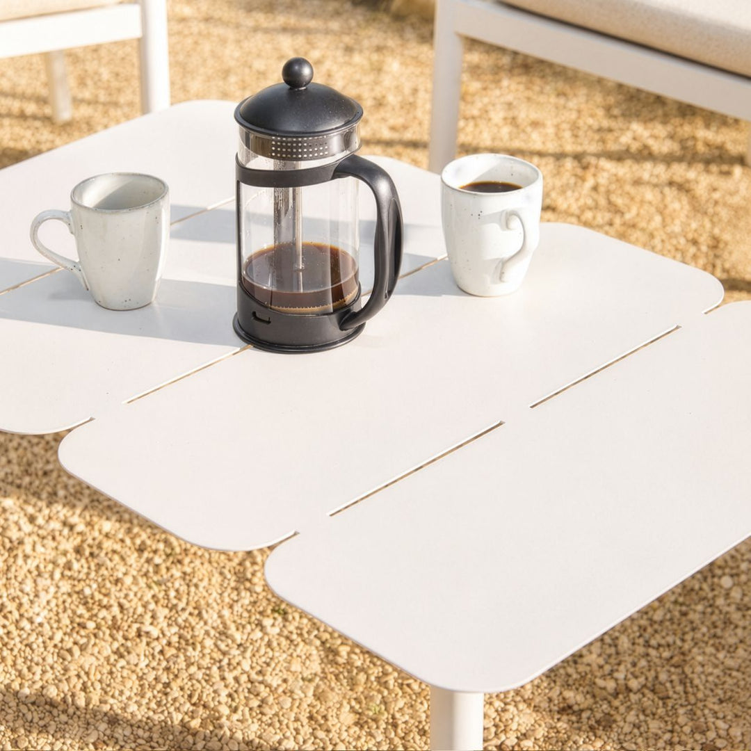 Contemporary powder-coated steel outdoor coffee table with rounded edges and slatted detailing