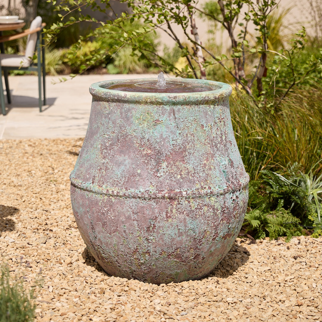 Decorative, extra large outdoor water feature in a garden setting