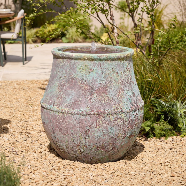 Decorative, extra large outdoor water feature in a garden setting
