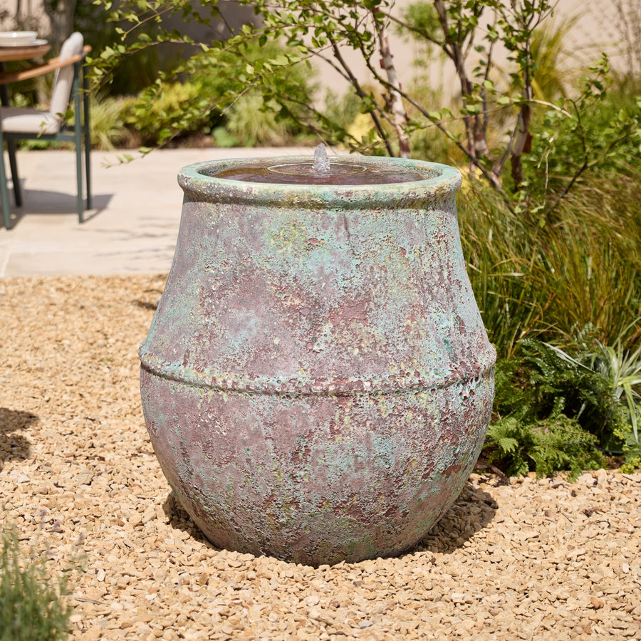 Decorative, extra large outdoor water feature in a garden setting