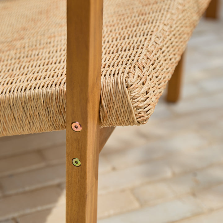 Close-up of a handwoven all-weather wicker chair seat attached to an acacia wood frame showing quality of craftsmanship.