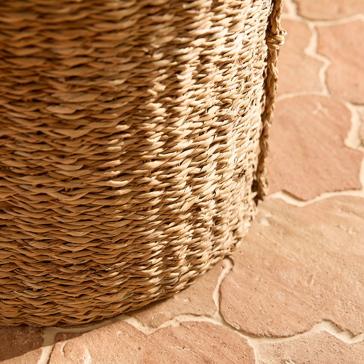 Close-up of a woven basket on a stone pavement