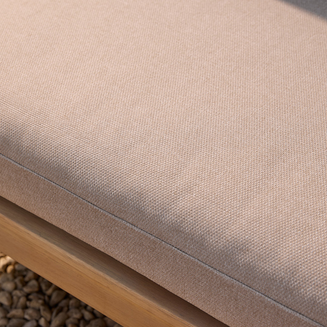 Close-up of a beige cushion on a wooden corner sofa