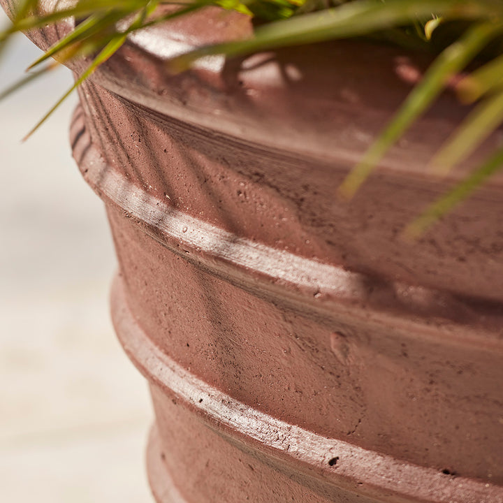 Close-up image of large glazed plant pot in brown with ribbed detailing, showing textured ancient glaze finish