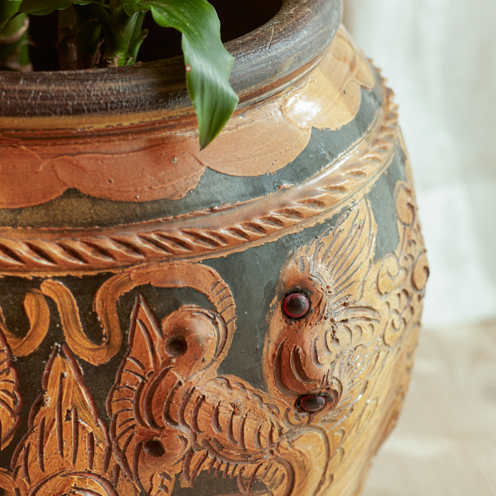 Close-up of the Phaya Indoor Plant Pot, highlighting its hand-carved detailing and rich earthy tones with sculptural embellishments.
