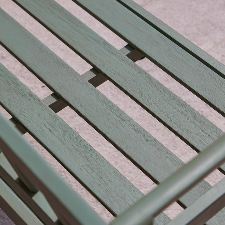 Close-up of green slatted seat on wooden garden bench, showing painted finish and sturdy eucalyptus frame.
