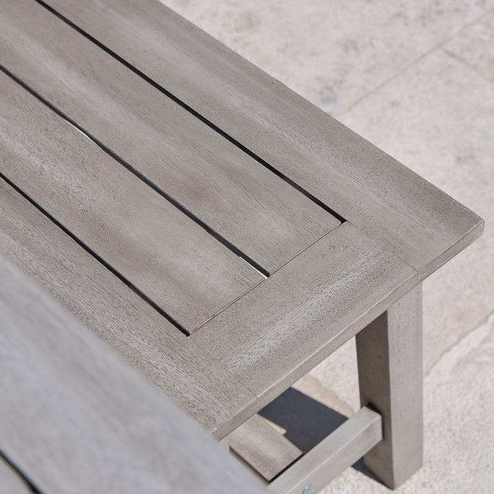 Close-up of slatted wooden dining bench from the Repton garden set with clean joins and grey wash finish.