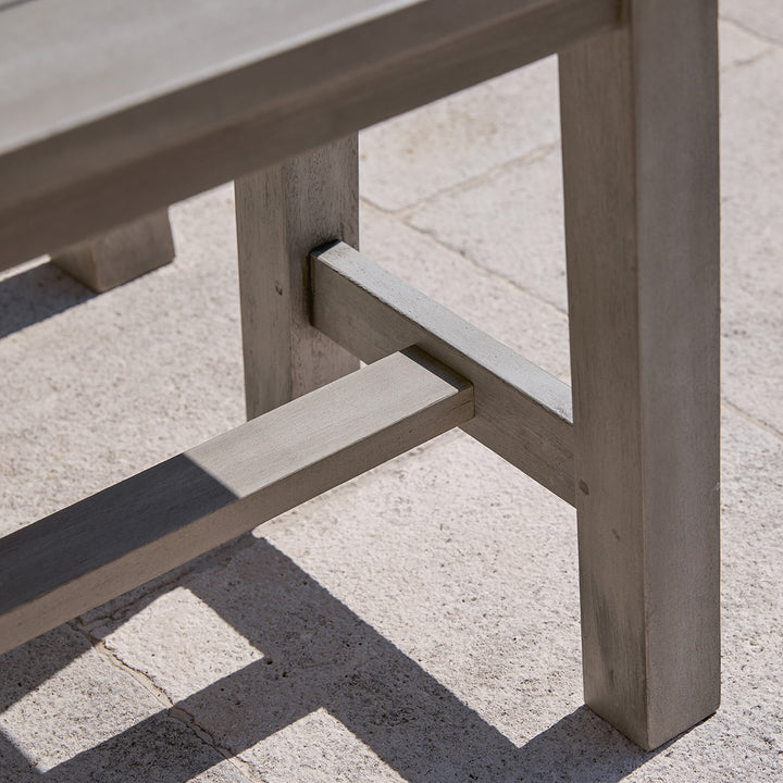 Joinery detail of Repton wooden garden dining set table, showing cross-leg construction in grey washed eucalyptus.