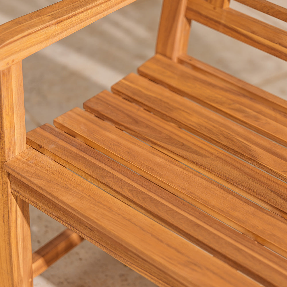Close-up of a wooden chair with slatted seat and backrest.