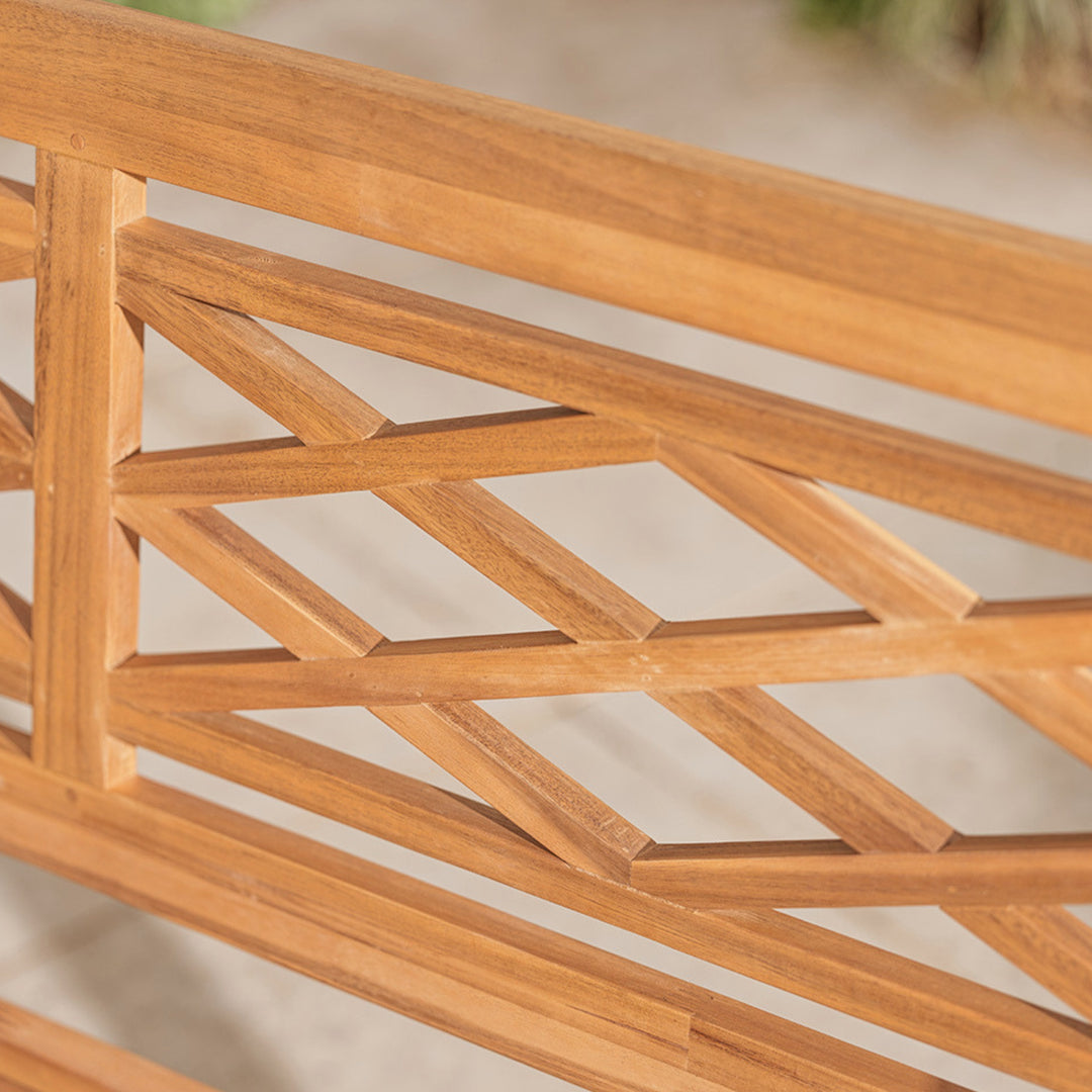 Close-up of a wooden lattice bench back structure with a blurred natural background
