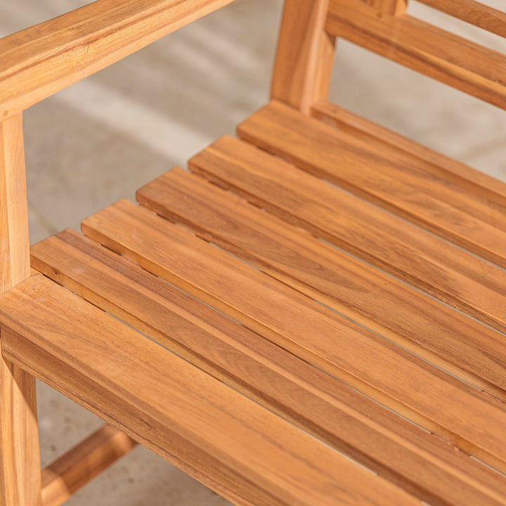 Close-up of a wooden chair with slatted seat and backrest.