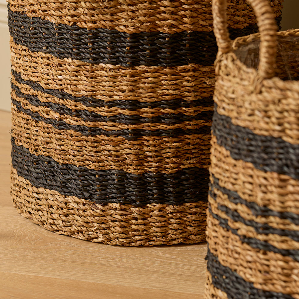 Woven baskets with striped pattern on a wooden surface