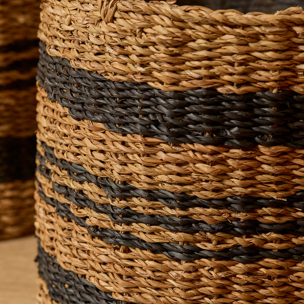 Close-up of a woven basket with brown and black stripes