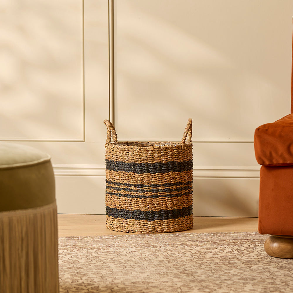 Woven basket with striped design on a neutral background